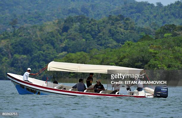 Alleged members of the peasant group "Encuentro Campesino" who has kidnapped four Belgian tourists are seen in a river boat in Rio Dulce, some 250 km...