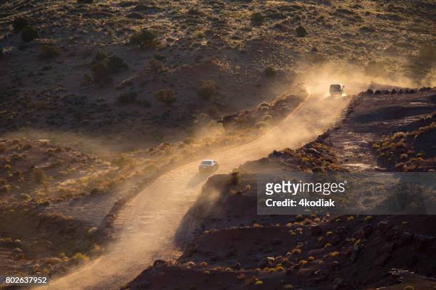 driving on dirt road - jeep desert stock pictures, royalty-free photos & images