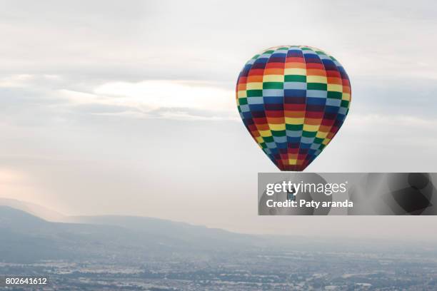 a multicolored balloon flying - leon e foto e immagini stock