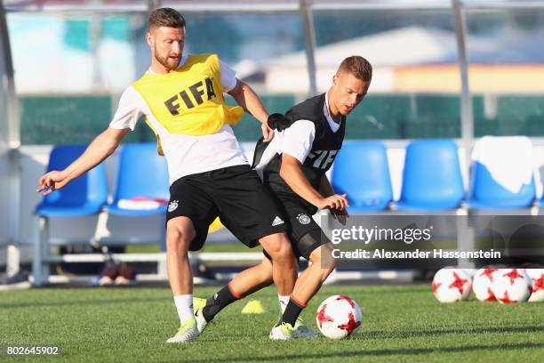 Shkodran Mustafi of Germany battles for the ball with his team mate Joshua Kimmich during a team Germany training session at Park Arena training...