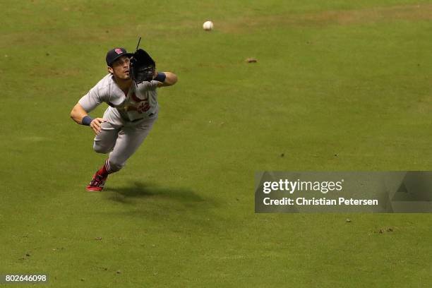 Outfielder Randal Grichuk of the St. Louis Cardinals makes a diving catch against the Arizona Diamondbacks during the ninth inning of the MLB game at...