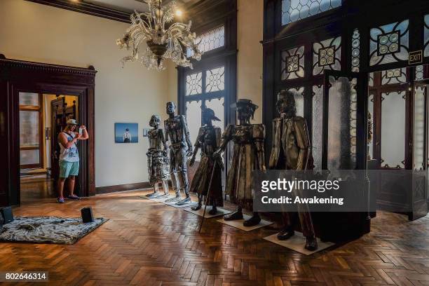 Visitor takes a picture in the Diaspora pavilion, where there are photographs on display by artist Khadija Saye, at Biennale Arte 2017 on June 28,...