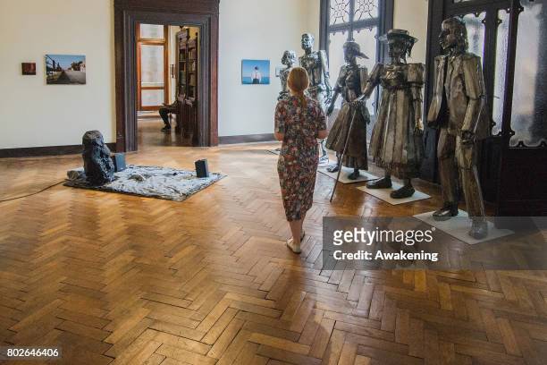 Visitor walks in the Diaspora pavilion, where there are photographs on display by artist Khadija Saye, at Biennale Arte 2017 on June 28, 2017 in...