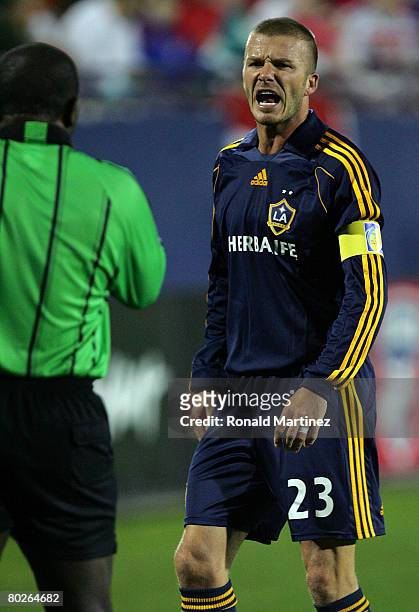 Midfielder David Beckham of the Los Angeles Galaxy yells while receiving a yellow card against FC Dallas during a charity preseason match on March...