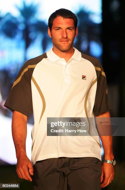 Jonathan Erlich of Israel walks on the runway as he participates in the Trina Turk Fashion Show during the Pacific Life Open at the Indian Wells...