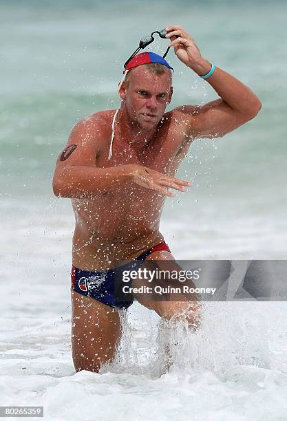 Trent Goulding of Half Moon Bay comes out of the water to win the Open Men's Ironman final during the Victorian State Surf Lifesaving Championships...