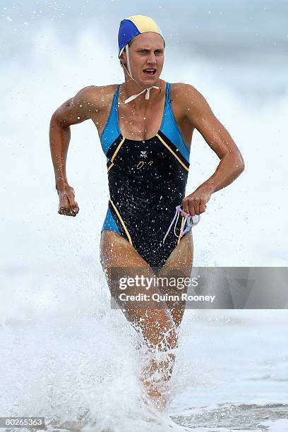 Harriet Brown of Ocean Grove comes out of the water to win the Open Women's Ironman final during the Victorian State Surf Lifesaving Championships at...