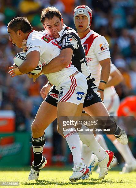 Rangi Chase of the Dragons is tackled during the round one NRL match between the Wests Tigers and the St George Illawarra Dragons at the Sydney...