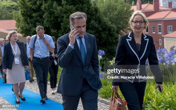 Mark Joseph Carney , Governor of the Bank of England and Chairman of the G20's Financial Stability Board, engages in a phone call while leaving the...