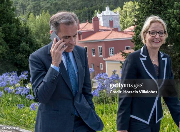 Mark Joseph Carney , Governor of the Bank of England and Chairman of the G20's Financial Stability Board, engages in a phone call while leaving the...