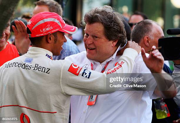 Lewis Hamilton of Great Britain and McLaren Mercedes celebrates in the paddock with Vice President of Mercedes-Benz Motorsport Norbert Haug after...