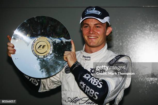 Nico Rosberg of Germany and Williams celebrates with his trophy after finishing third in the Australian Formula One Grand Prix at the Albert Park...