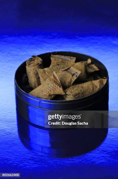 container of chewing tobacco pouches on a blue background - pouch stock pictures, royalty-free photos & images