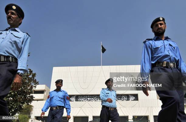 Pakistani police commandos march outside the Parliament building in Islamabad on March 16, 2008 on the eve of the first session of the new Parliament...