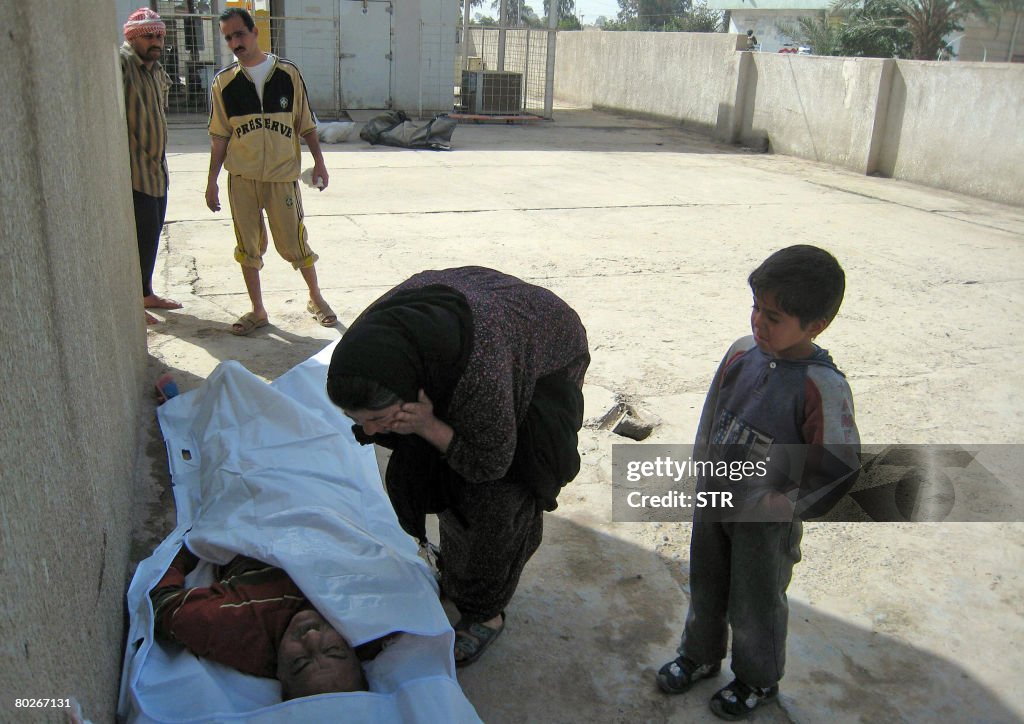 An Iraqi woman mourns over the body of h