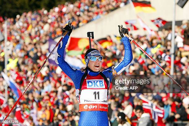 Michaela Ponza of Italy reacts as she crosses the finish line to place third in women's 12.5 km mass start at the World Cup Biathlon ski race in Oslo...