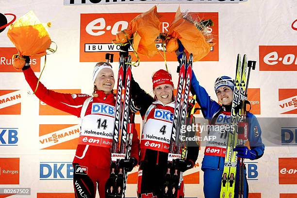 Second placed Solveig Rogstad of Norway, first placed Kati Wilhelm of Germany and third placed Michela Ponza of Italy are pictured on the podium...
