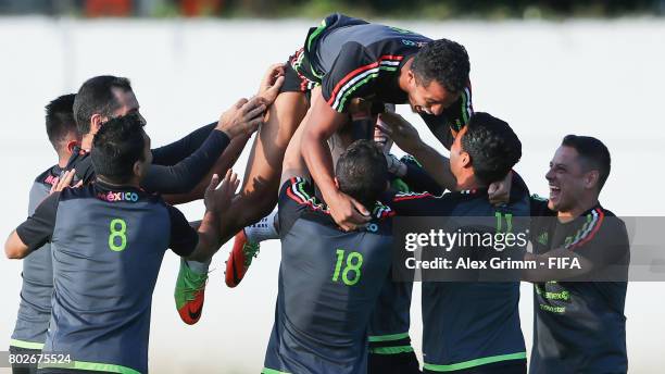 Giovani dos Santos is lifted up into the air by his team mates during a Mexico press conference at Fisht Olympic stadium ahead of their FIFA...