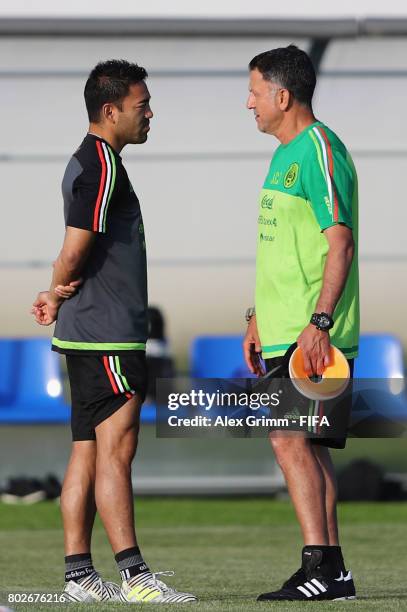 Head coach Juan Carlos Osorio talks to Marco Fabian during a Mexico training session at Adler training ground ahead of their FIFA Confederations Cup...
