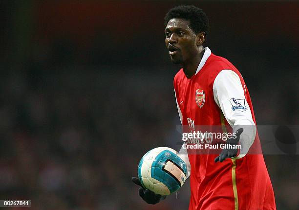 Emmanuel Adebayor of Arsenal contests a decision with the assistant referee during the Barclays Premier League match between Arsenal and...