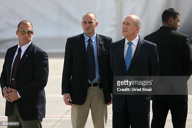 Israeli Prime Minister Ehud Olmert waits for the arrival of German Chancellor Angela Merkel on March 16, 2008 at Ben Gurion International Airport,...