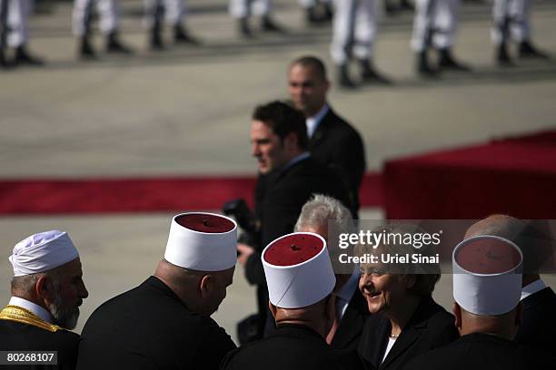 German Chancellor Angela Merkel is welcomed by Israeli Prime Minister Ehud Olmert on March 16, 2008 at Ben Gurion International Airport, southeast of...