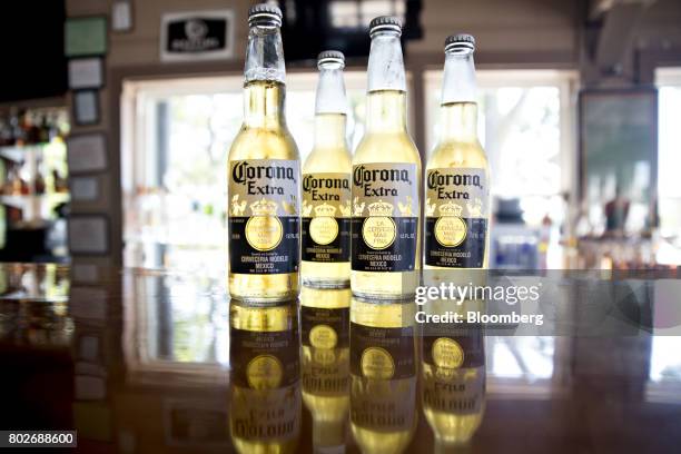 Bottles of Constellation Brands Inc. Corona beer stand on a counter in an arranged photograph at a restaurant in Ottawa, Illinois, U.S., on Tuesday,...