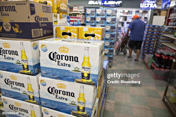 Cases of Constellation Brands Inc. Corona beer sit on display for sale at a liquor store in Ottawa, Illinois, U.S., on Tuesday, June 27, 2017....