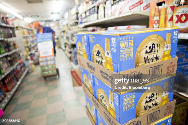 Cases of Constellation Brands Inc. Modelo beer sit stacked during a delivery at a liquor store in Ottawa, Illinois, U.S., on Tuesday, June 27, 2017....