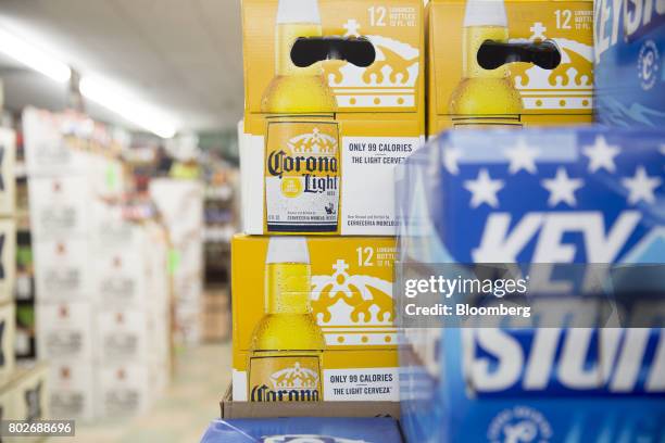 Cases of Constellation Brands Inc. Corona beer sit on display for sale at a liquor store in Ottawa, Illinois, U.S., on Tuesday, June 27, 2017....