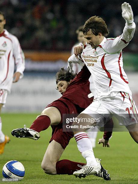 Dmitri Sychev of FC Lokomotiv Moscow competes for the ball with Roman Sharonov of FC Rubin Kazan during the Russian Football League Championship...