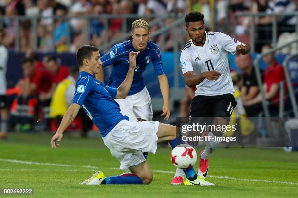Mattia Caldara of Italy Andrea Conti of Italy and Serge Gnabry of Germany battle for the ball during the UEFA U21 championship match between Italy...