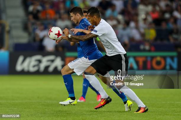 Mattia Caldara of Italy and Davie Selke of Germany battle for the ball during the UEFA U21 championship match between Italy and Germany at Krakow...