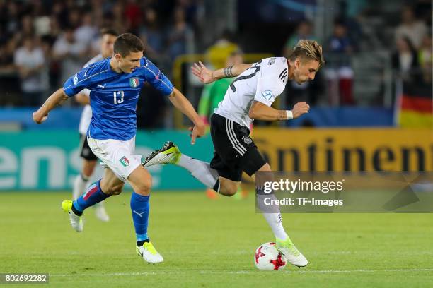 Mattia Caldara of Italy and Maximilian Philipp of Germany battle for the ball during the UEFA U21 championship match between Italy and Germany at...