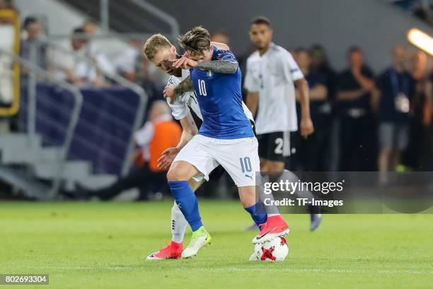 Mitchell Weiser of Germany and Federico Bernardeschi of Italy battle for the ball during the UEFA U21 championship match between Italy and Germany at...