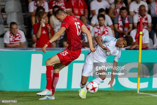 Jaroslaw Jach of Poland and Mason Holgate of England battle for the ball during the UEFA European Under-21 Championship Group A match between England...