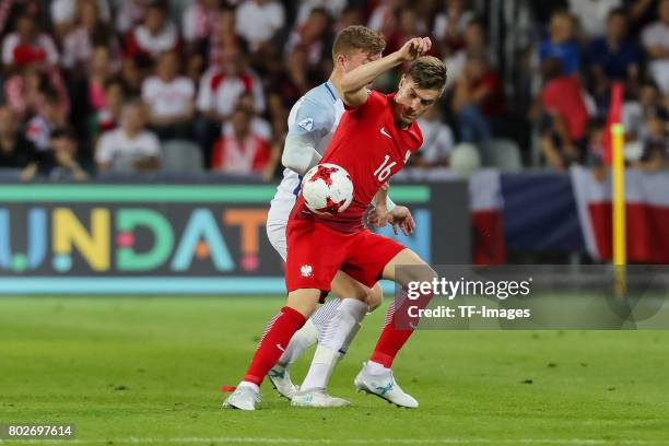 Alfie Mawson of England and Krzysztof Piatek of Poland battle for the ball during the UEFA European Under-21 Championship Group A match between...