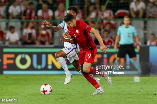 Jacob Murphy of England and Mariusz Stepinski of Poland battle for the ball during the UEFA European Under-21 Championship Group A match between...