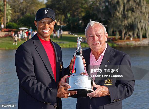 Tiger Woods poses with the winners trophy and Arnold Palmer after his victory in the Arnold Palmer Invitational presented by MasterCard held on March...