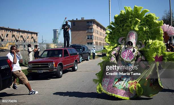 Mardi Gras Indian passes the B.W. Cooper housing projects in the annual Super Sunday second line parade March 16, 2008 in New Orleans, Louisiana....