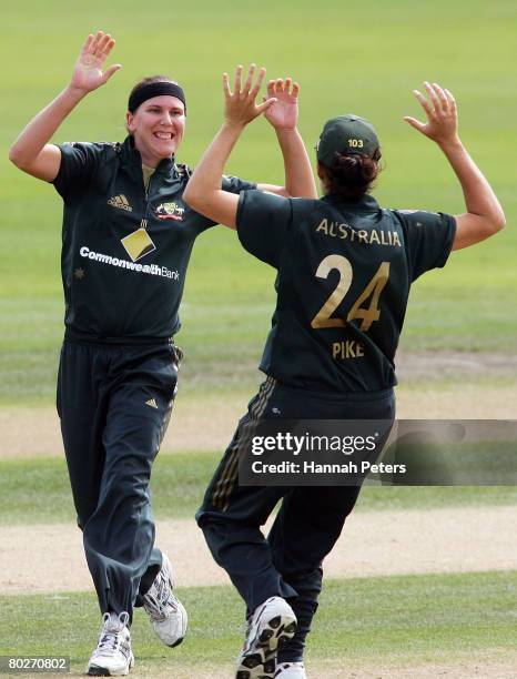 Emma Sampson of Australia celebrates with Kirsten Pike after claiming the wicket of Aimee Mason of New Zealand during the fourth Rose Bowl Series One...