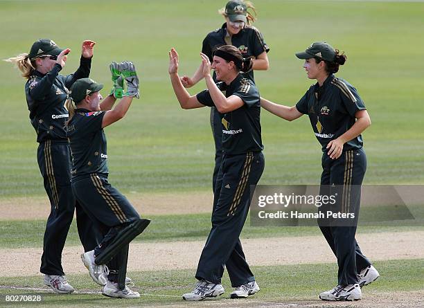 Emma Sampson of Australia celebrates with her team-mates after claiming the wicket of Aimee Mason of New Zealand during the fourth Rose Bowl Series...