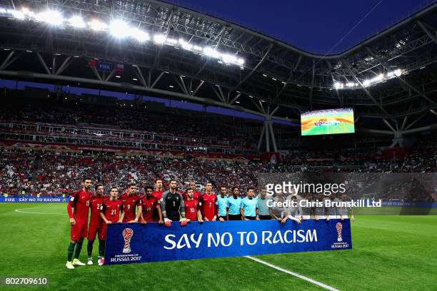 The teams lineup with an anti racism banner before the FIFA Confederations Cup Russia 2017 Semi-Final between Portugal and Chile at Kazan Arena on...
