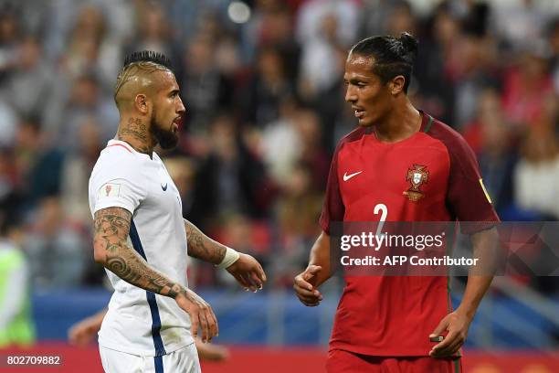 Chile's midfielder Arturo Vidal speaks with Portugal's defender Bruno Alves during the 2017 Confederations Cup semi-final football match between...