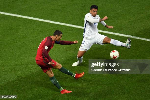 Cristiano Ronaldo of Portugal shoots as Gonzalo Jara of Chile attempts to block during the FIFA Confederations Cup Russia 2017 Semi-Final between...