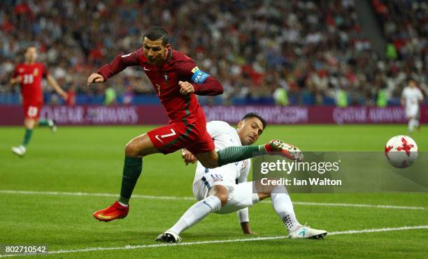 Gonzalo Jara of Chile tackles Cristiano Ronaldo of Portugal during the FIFA Confederations Cup Russia 2017 Semi-Final between Portugal and Chile at...