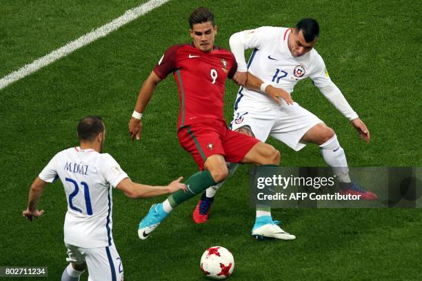 Portugal's forward Andre Silva vies with Chile's midfielder Marcelo Diaz and Chile's defender Gary Medel during the 2017 Confederations Cup...