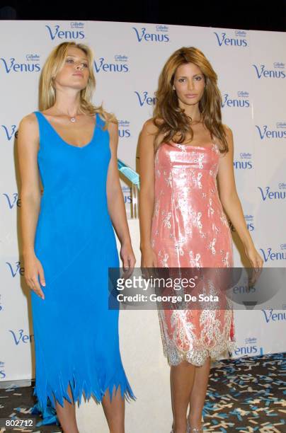 Fashion models Daniela Pestova, left, and Elsa Benitez pose for photographers April 17, 2001 at Grand Central Station in New York City during a...