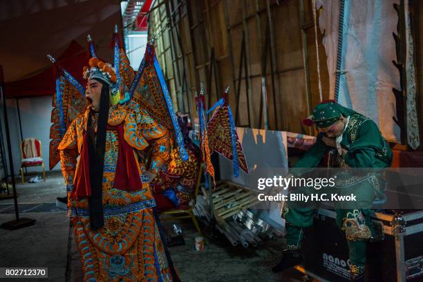 Performers take a break back stage during the Guan Gong festival, a door god in Chinese and Taoist temples also known as Lord Guan ahead of the 20th...