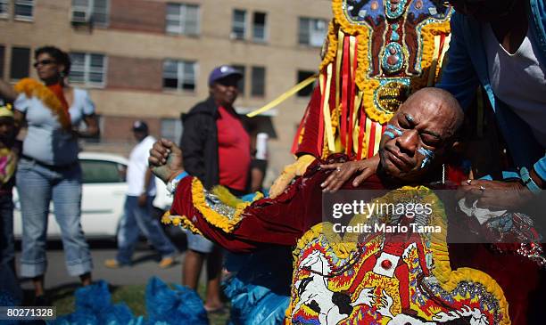 Mardi Gras Indian Gerard Lewis, Big Chief of the Black Eagles, is consoled as the parade passes the B.W. Cooper housing projects in the annual Super...